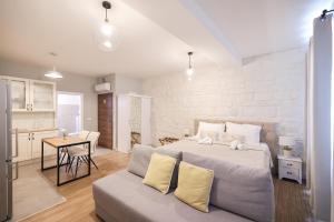 a bedroom with a large bed and a living room at Elegance Studio Apartments in Zadar