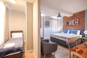 a small room with a bed and a desk with a chair at Elegance Studio Apartments in Zadar