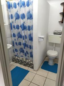 a bathroom with a toilet and a shower curtain at 74 On Ridge in Bazley Beach