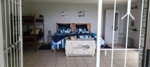 a bedroom with a bed with blue and white sheets at 74 On Ridge in Bazley Beach