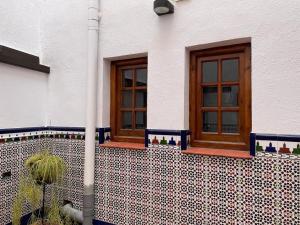 a house with two windows on the side of it at Habitación con encanto in Granada