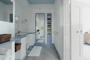 W białej łazience znajduje się umywalka i lustro. w obiekcie Wohnen im Wasserschloss Sandizell w mieście Schrobenhausen