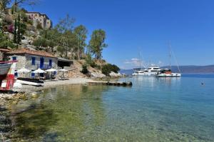 a body of water with boats in the water at Douskos by the Sea in Mandraki