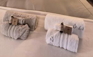a group of towels on a bed at o le zen in Saint-Juire-Champgillon