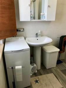 a small bathroom with a sink and a toilet at casa indipendente con accesso diretto al mare in Ovile la Marina