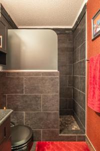 a bathroom with a shower with gray tile at Contemporary Paradise w/ Private Bathroom in Nashville