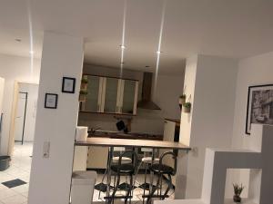 a kitchen with a counter and some chairs in it at casabella in Leverkusen
