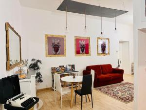 a living room with a red couch and a table at Palazzo delle Logge in Palermo