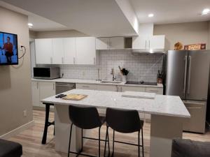 a kitchen with a white counter top and a refrigerator at Lakeview in Peachland