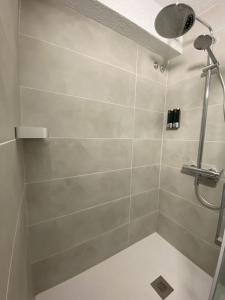 a bathroom with a shower with a shower head at El Patio Hostal in Alicante