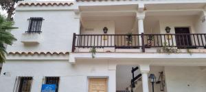 a white building with a balcony with plants on it at Apartamento 309 frente al mar en Alcossebre in Alcossebre