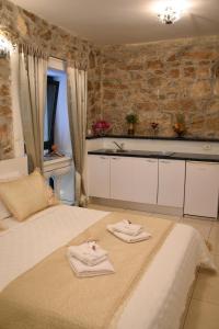 a bedroom with a bed with two towels on it at Apartments Bepina in Split