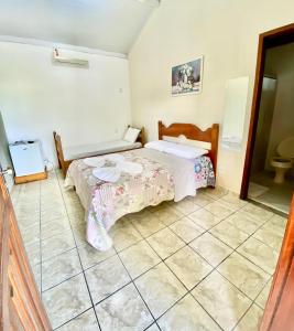 Cama o camas de una habitación en Pousada Aruanã