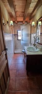 a bathroom with a tub and a sink and a shower at Casa rural La Piedrapipa in Madrigal de la Vera