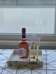 una botella de vino en una caja con dos copas de champán en Apartmán Simcity 2 en Banská Bystrica
