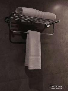 a towel rack with towels on it in a bathroom at Deck 3 Savynomad Harbour Residences wow Views in Cospicua