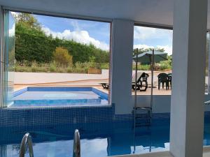 a swimming pool with a view of a patio from a house at Apartamentos Harrigorri in Barrika