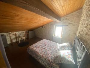 a bedroom with a bed and a window at Gîte 8 personnes in Sainte-Croix-du-Mont