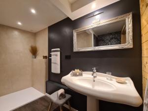 uma casa de banho com um lavatório e um espelho em La Grange du couvent B&B em Ribeauvillé