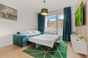 a bedroom with a blue bed and a window at LAM Green w AC & balcony in Bratislava