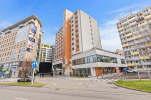 an empty street in a city with tall buildings at LAM Green w AC & balcony in Bratislava