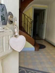a heart shaped lock on a door with a hallway at Le Gite de la Poterne, maison en bordure du Serein in Chablis