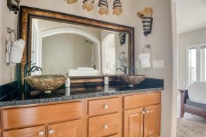 a bathroom with two sinks and a large mirror at Seascape Rockaway - Meredith Lodging in Rockaway Beach +53 photos