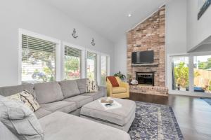 a living room with a couch and a fireplace at Beauty on the Water! Lake House near the beaches! in Galveston