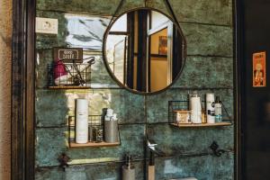 een badkamer met een spiegel en een wastafel bij Q PODGORICA Beds,Rooms and more in Podgorica
