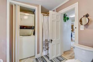 a bathroom with a toilet and an open door at The Historic Blue Bird Cottage in Colorado Springs