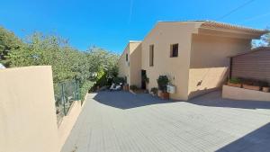 a house with a driveway next to a building at Casa NeGo in Calpe