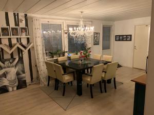 a dining room with a black table and chairs at OWN ROOM WITH BIG BED IN A BIG HOUSE! in Luleå