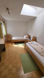 a large room with two beds and a window at Gasthof Moser in Fohnsdorf