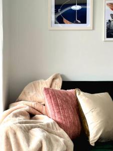 a pile of blankets and pillows on a bed at Quirky, Family Home in Glasgow in Cardonald