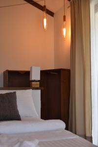 a bedroom with a bed with lights on the wall at Cascina Tre Botti in Agliano Terme