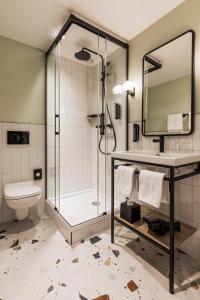 a bathroom with a shower and a toilet and a sink at Faern Crans-Montana Valaisia in Crans-Montana