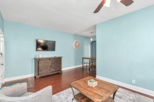 a living room with blue walls and a table at Historical Galveston House - 2 min drive to sand!! in Galveston