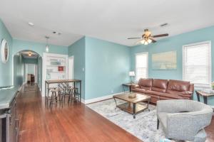 a living room with blue walls and a couch and a table at Historical Galveston House - 2 min drive to sand!! in Galveston