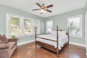 a bedroom with a bed and a ceiling fan at Historical Galveston House - 2 min drive to sand!! in Galveston