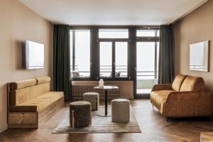 a living room with a couch and a chair at Faern Crans-Montana Valaisia in Crans-Montana