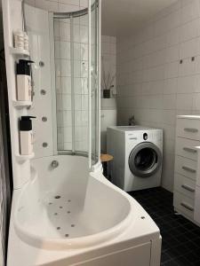 a bathroom with a shower and a washing machine at House in the nature, Tromsø in Tromsø +16 photos