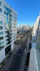 a view of a street in a city with buildings at Apartamento 2 quartos completo 200 m da praia in Capão da Canoa