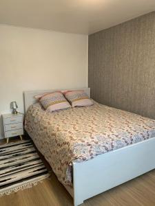 a bedroom with a bed with two pillows on it at Convivialetzen in Châtenoy-le-Royal