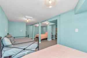 a bedroom with blue walls and a bed at Sleeps 19! 3 Kitchens, LR's, 4 BR 4.5 BTH - Beauty in Galveston
