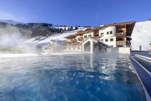 a swimming pool at a hotel in the snow at Natur- & Wanderhotel Tuxertal in Tux