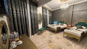 a bedroom with two beds and a chandelier at Ethnica Suites in Istanbul