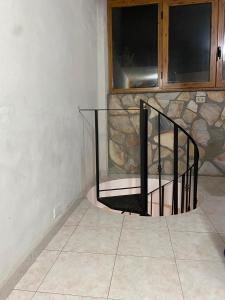 een trap in een kamer met een stenen muur bij Villa Sophie in SantʼAgata di Militello