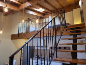 a staircase in a house with a wooden ceiling at Borgo Antico Lake Endine Hospitality in Endine Gaiano
