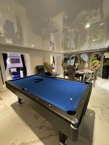 uma mesa de bilhar no meio de um quarto em Chambre de luxe familiale 95 Bleu em Deuil-la-Barre