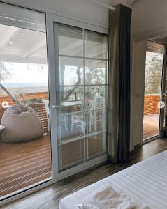 a bedroom with sliding glass doors leading to a balcony at ALEVRA in Dhërmi